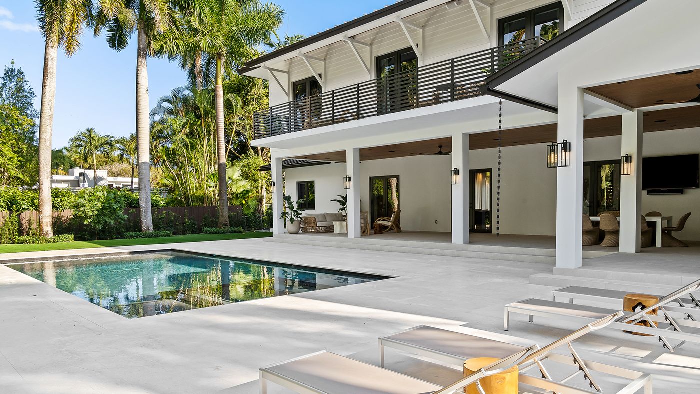 Rear elevation with two-story loggias, pool and royal palms